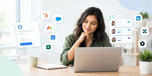 12 Best Lead Capture Software Tools You Need to Try in 2026 Woman using a laptop with lead capture forms and CRM data displayed around her.